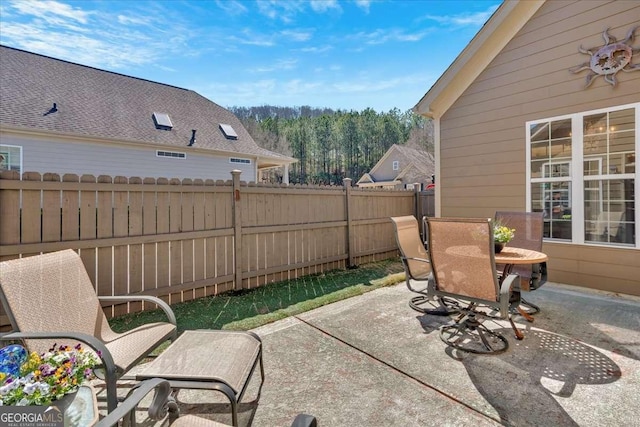 view of patio featuring fence