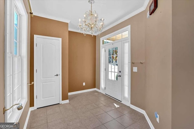 entrance foyer with baseboards, light tile patterned floors, a chandelier, and crown molding