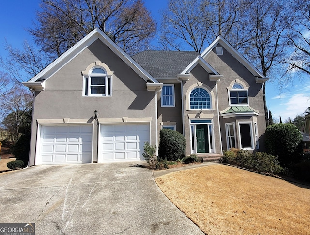 traditional home with driveway and stucco siding