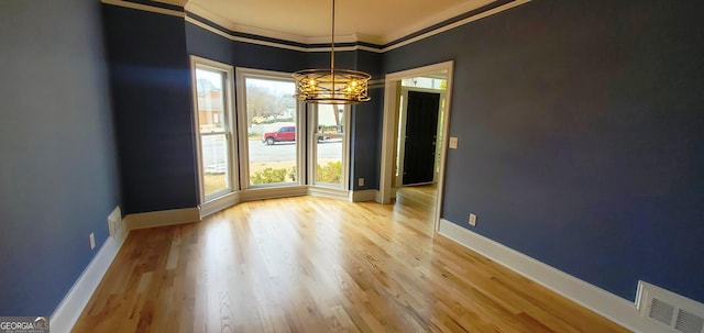 2899 Greystone Cv N, Atlanta, GA 30341 - unfurnished dining area featuring a chandelier, ornamental molding, light wood-type flooring, and baseboards