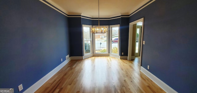 2899 Greystone Cv N, Atlanta, GA 30341 - unfurnished dining area featuring wood finished floors, crown molding, and baseboards