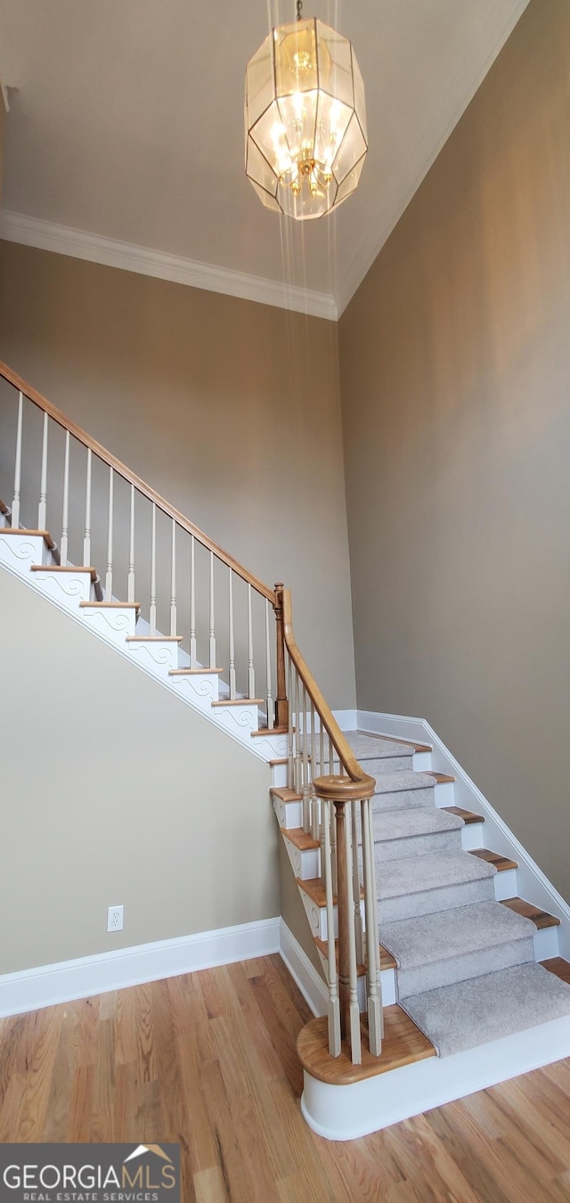 2899 Greystone Cv N, Atlanta, GA 30341 - stairway with wood finished floors, baseboards, a chandelier, and ornamental molding