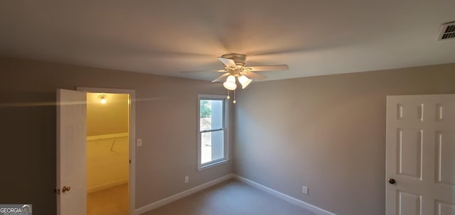 2899 Greystone Cv N, Atlanta, GA 30341 - unfurnished bedroom with baseboards, a ceiling fan, and a spacious closet