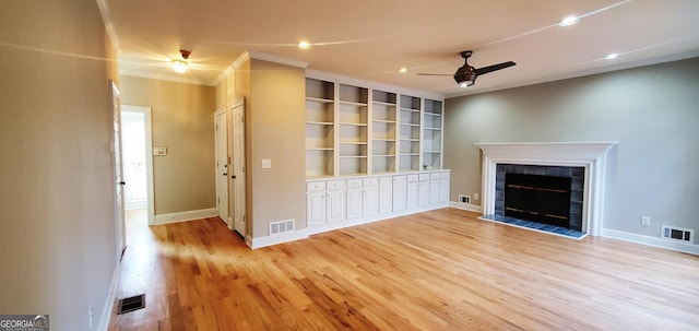 2899 Greystone Cv N, Atlanta, GA 30341 - unfurnished living room featuring a ceiling fan, crown molding, light wood-style floors, a tile fireplace, and recessed lighting