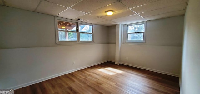 2899 Greystone Cv N, Atlanta, GA 30341 - basement with wood finished floors, a paneled ceiling, and baseboards