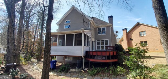 2899 Greystone Cv N, Atlanta, GA 30341 - rear view of house with a sunroom and a chimney