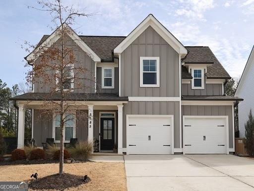 view of front of property with driveway, board and batten siding, and an attached garage