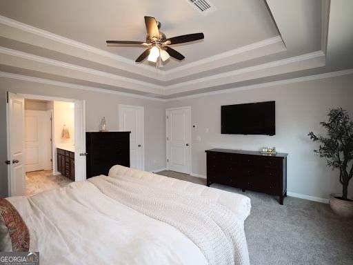 bedroom with visible vents, ornamental molding, a tray ceiling, baseboards, and ceiling fan