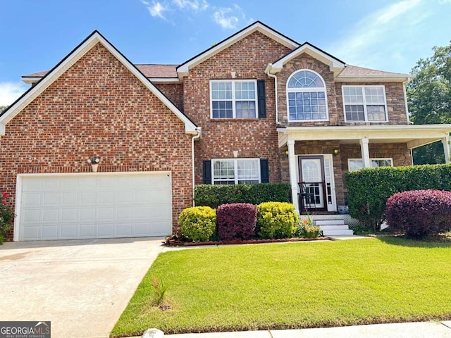 view of front facade with a garage, concrete driveway, brick siding, and a front yard