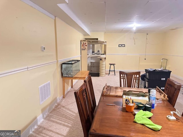 dining area with carpet, visible vents, and baseboards