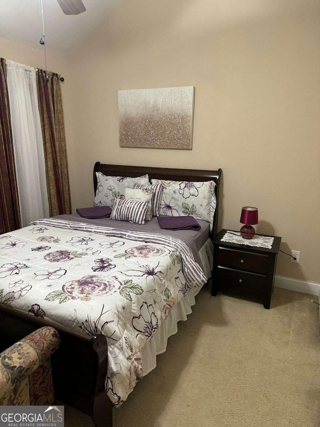 bedroom featuring carpet, baseboards, and vaulted ceiling