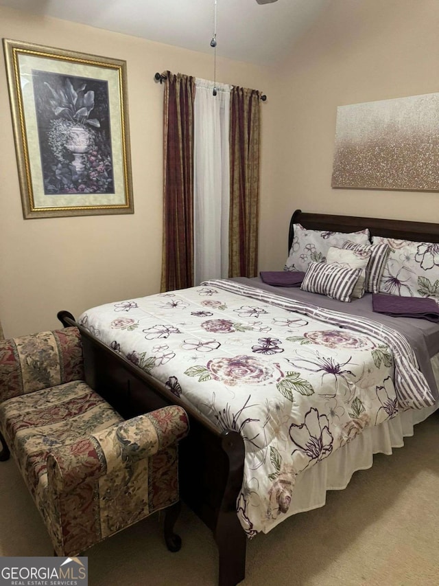 carpeted bedroom featuring vaulted ceiling