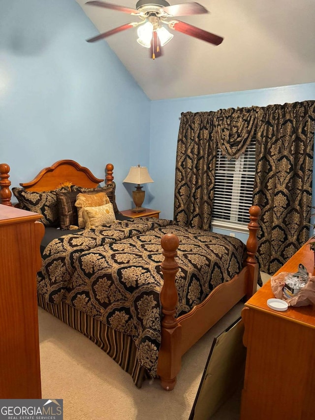 carpeted bedroom with vaulted ceiling and ceiling fan