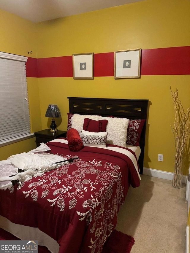 carpeted bedroom featuring baseboards