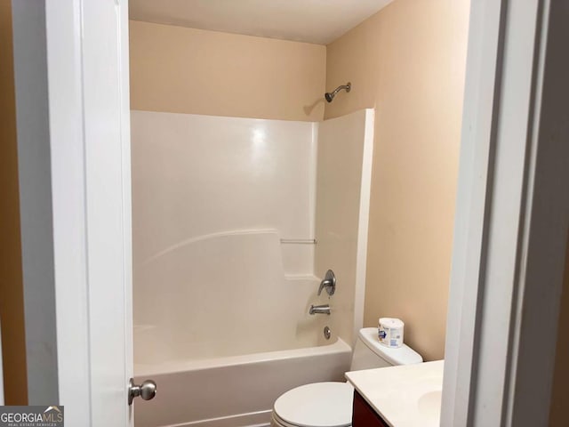 bathroom with toilet, bathing tub / shower combination, and vanity