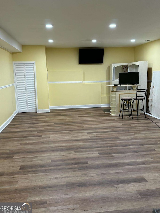 interior space with recessed lighting, baseboards, and wood finished floors