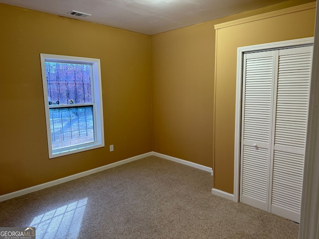 unfurnished bedroom featuring a closet, visible vents, and baseboards