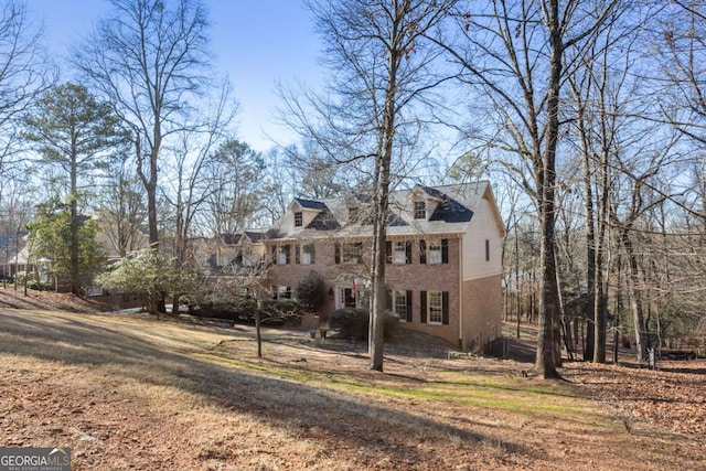 georgian-style home featuring brick siding