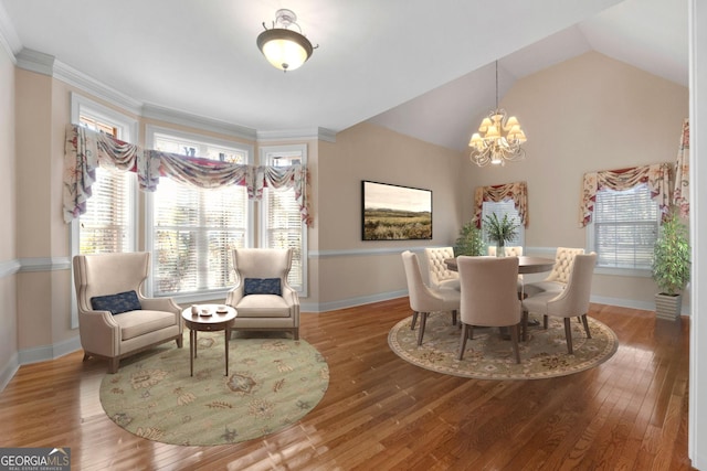 dining area with a notable chandelier, hardwood / wood-style floors, and a healthy amount of sunlight