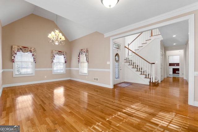 entryway with light wood-style flooring, a notable chandelier, visible vents, baseboards, and stairway