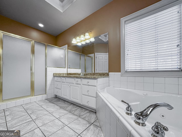 bathroom featuring a stall shower, vanity, and a whirlpool tub