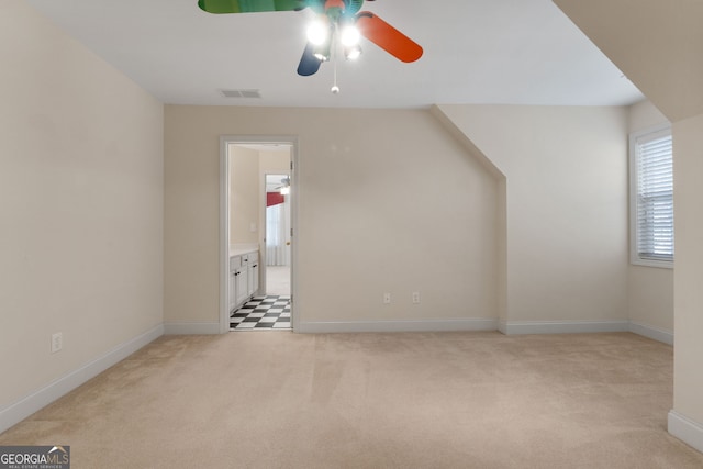 bonus room with light colored carpet, visible vents, and baseboards