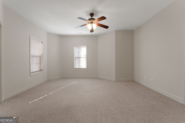 unfurnished room featuring light carpet, ceiling fan, and baseboards