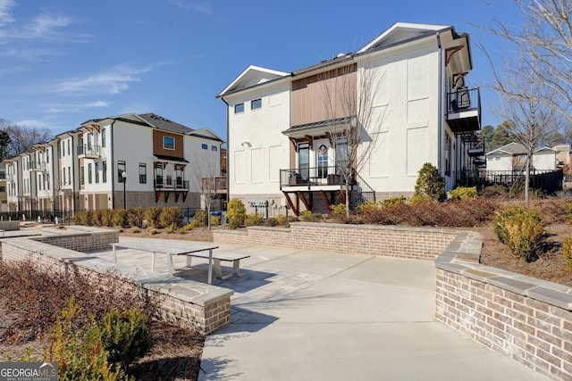 view of property's community featuring a residential view and fence