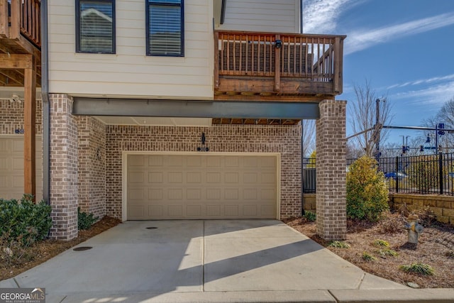 garage with driveway and fence