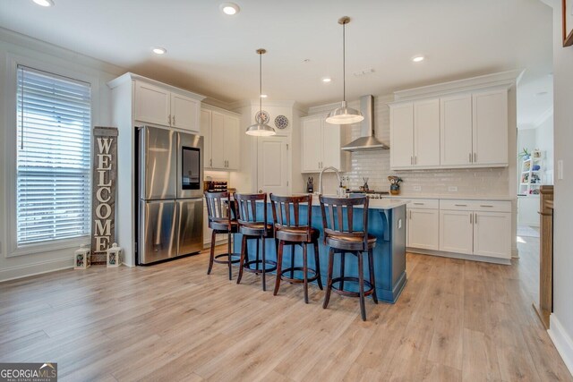 kitchen with a breakfast bar area, light wood finished floors, smart refrigerator, white cabinetry, and wall chimney exhaust hood