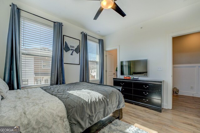 bedroom with a ceiling fan and wood finished floors