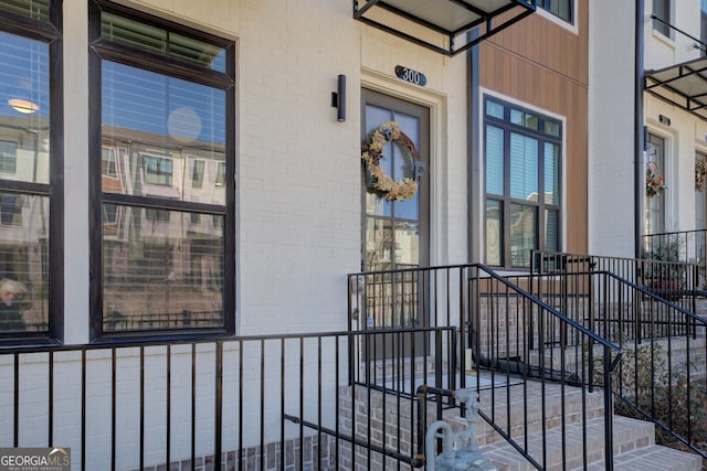 doorway to property with brick siding