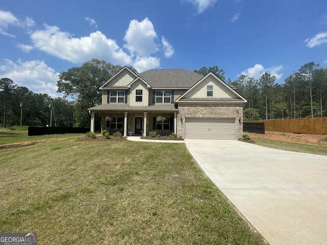 view of front of property featuring a garage, concrete driveway, fence, and a front lawn