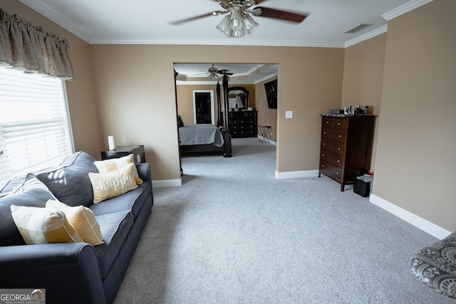 carpeted living room with baseboards, visible vents, ceiling fan, and ornamental molding