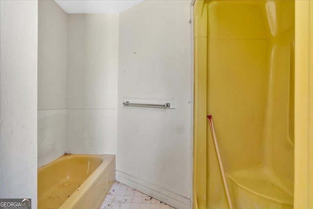 full bathroom with a bathtub and baseboards