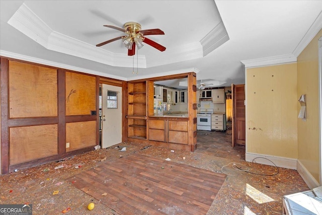 interior space with ceiling fan, ornamental molding, and a raised ceiling