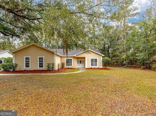 single story home featuring stucco siding and a front yard