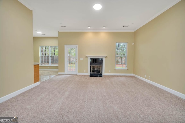 unfurnished living room featuring baseboards, light colored carpet, ornamental molding, recessed lighting, and a fireplace