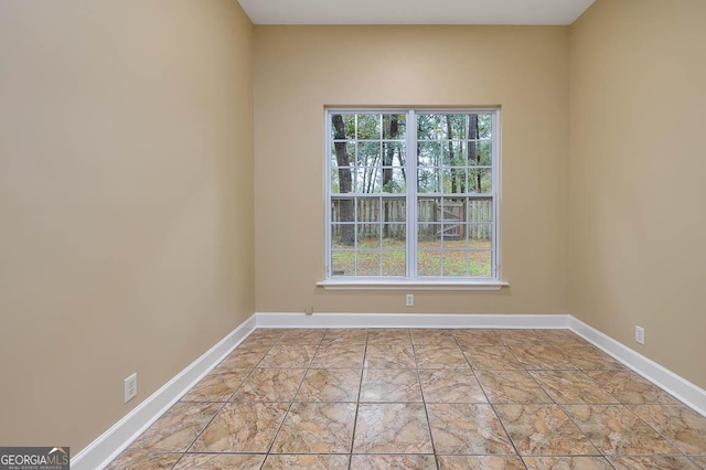 empty room with baseboards and a wealth of natural light