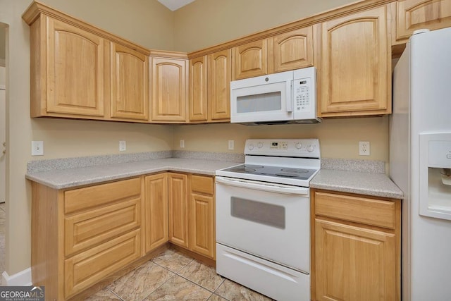 kitchen featuring white appliances, light brown cabinets, and light countertops