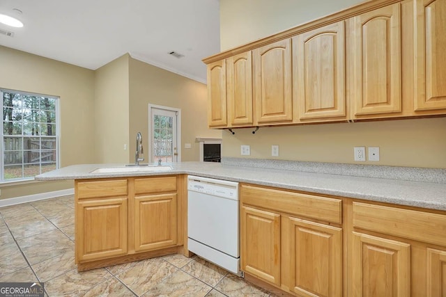 kitchen featuring light brown cabinets, a peninsula, a sink, light countertops, and dishwasher