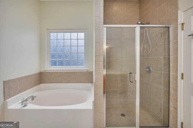 full bath with a shower stall and a garden tub