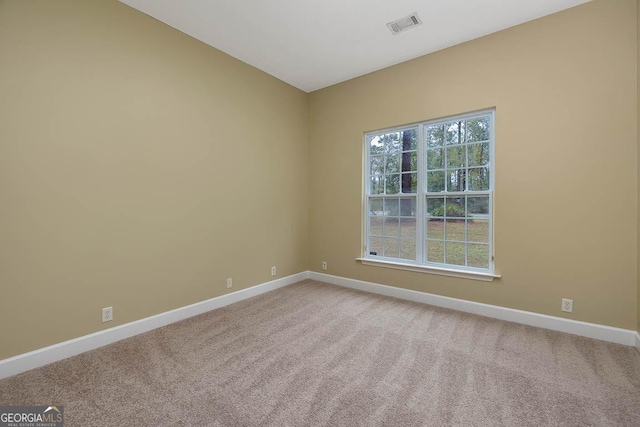 unfurnished room with visible vents, baseboards, and carpet floors