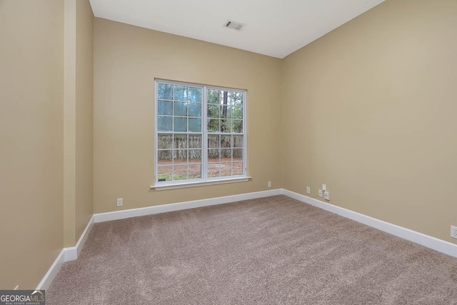 unfurnished room with visible vents, carpet, and baseboards