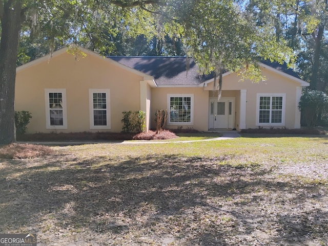 ranch-style house with stucco siding and a front lawn