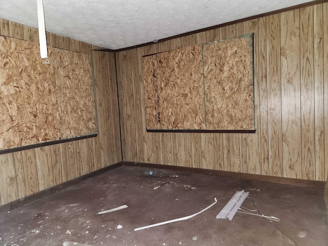 spare room featuring baseboards and a textured ceiling