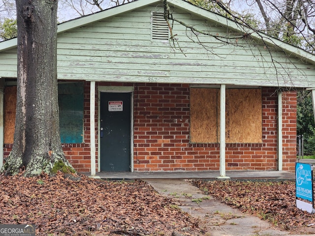 exterior space with brick siding