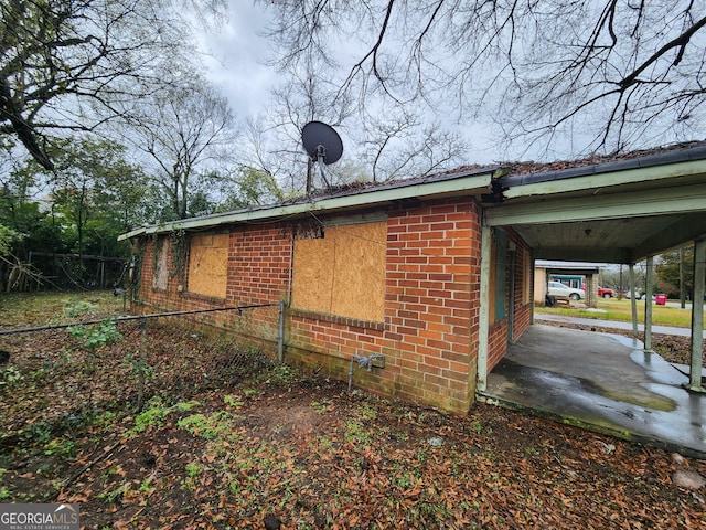 view of side of property featuring brick siding