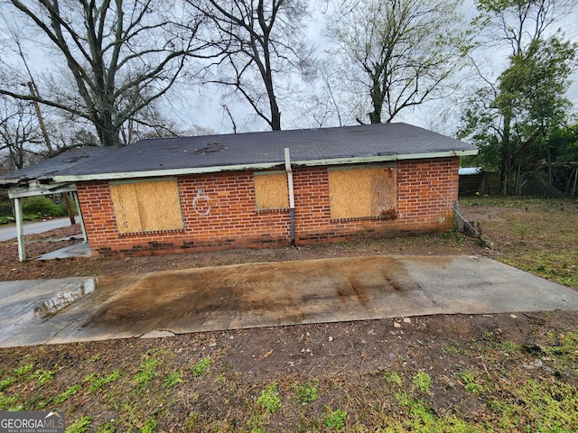 exterior space featuring a patio area and brick siding