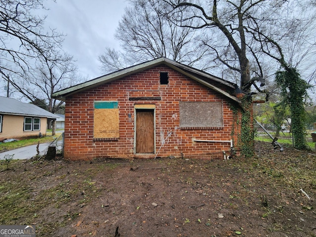 back of house with brick siding